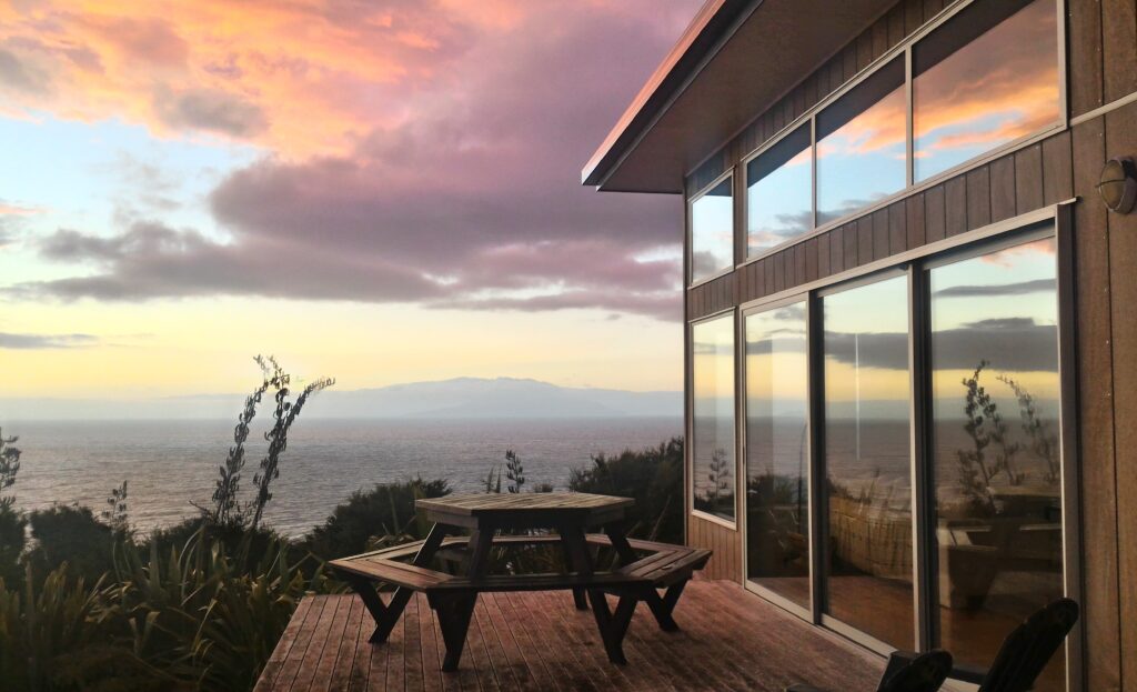 Sunset views to Hauturu from the deck at XSPOT Cliff House Great Barrier Island